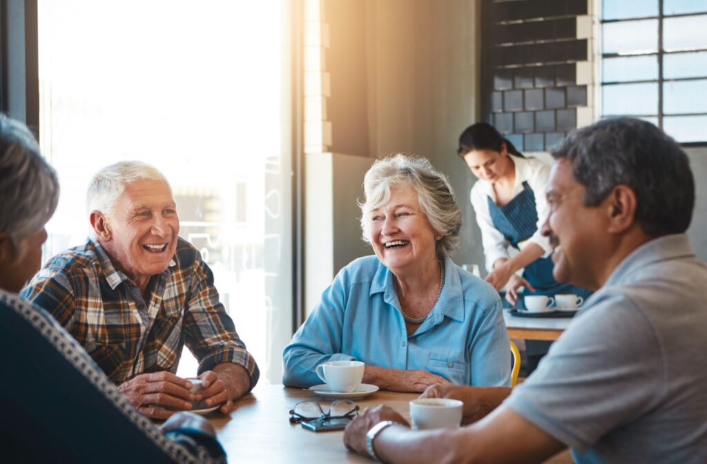 A group of seniors enjoying coffee together with friends at a senior living community.