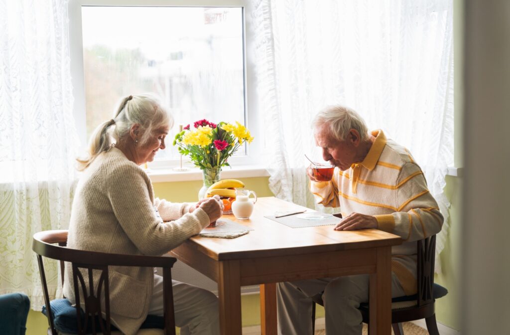 A senior couple enjoying morning coffee at the table.